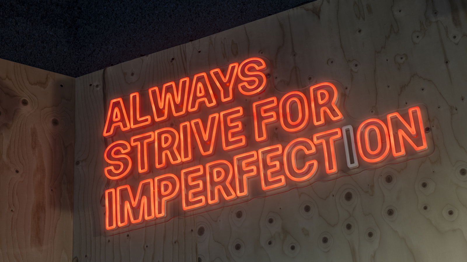 always strive for imperfection slogan at the includi office